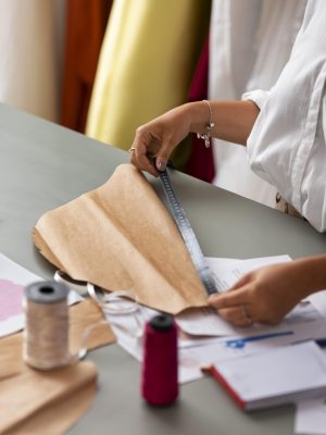 high-angle-woman-working-as-clothing-designer-min